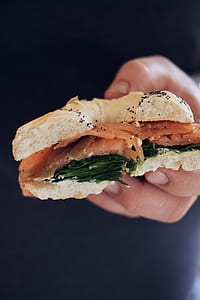 person holding meat with bun thumbnail