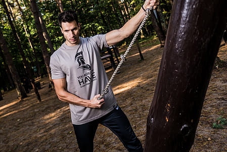 man wearing gray shirt holding rope thumbnail