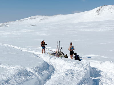 women standing on snow covered land thumbnail