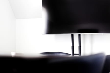 turned-off gray flat screen TV inside white room thumbnail