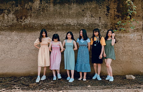 Six Women Leaning on Brown Wall thumbnail