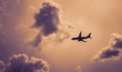 silhouette of a plane flying above the sky thumbnail