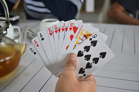 person holding playing cards thumbnail