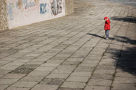 boy standing on pavement during daytime thumbnail