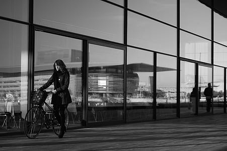 woman holding bicycle grayscale photo thumbnail