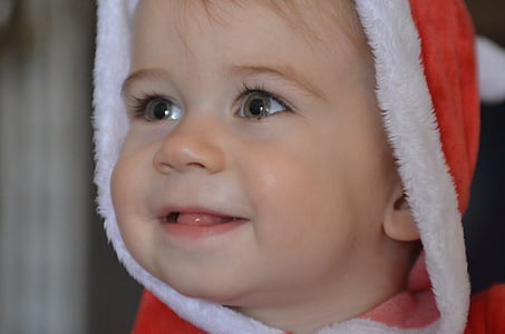 closeup photography of baby boy smiling and wearing red and white hoodie thumbnail