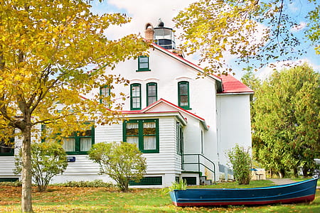 white 3-story house with blue boat on garage thumbnail
