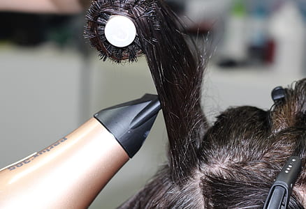 person holding brown and black hair dryer thumbnail