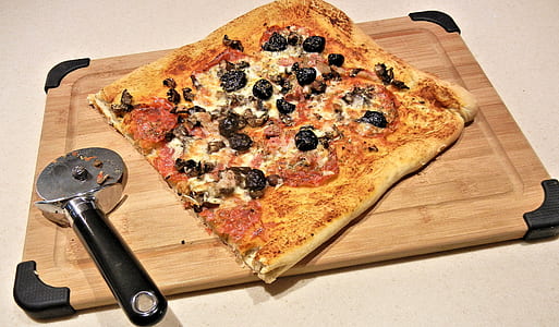 cooked pizza on brown wooden tray thumbnail