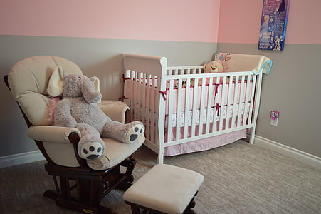 glider chair beside crib thumbnail