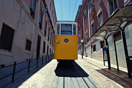 Wide angle shot of a classic yellow tram in the centre of Lisbon, Portugal thumbnail