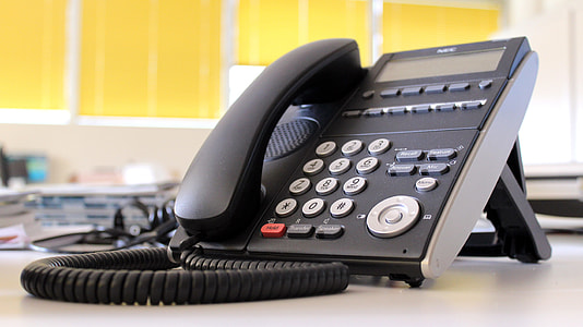 black caller ID telephone on white surface thumbnail