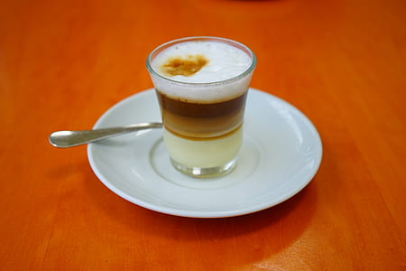 clear drinking glass on white saucer thumbnail