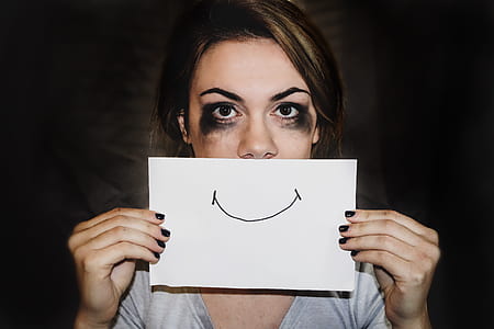 woman holding white printer paper with smiley sketch thumbnail