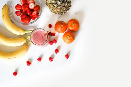 strawberries on clear glass bowl beside three bananas thumbnail