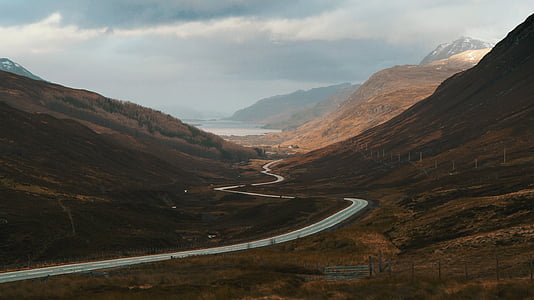 gray road in between mountains thumbnail