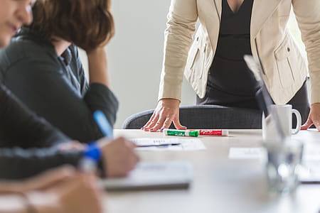 Powerful Woman Leaning On Desk Photo thumbnail