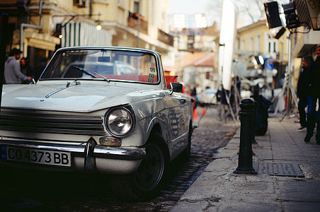 classic white convertible coupe park on roadside during daytime thumbnail