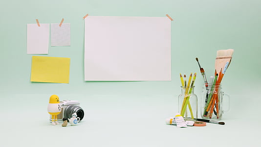 pencils in clear glass jar against papers at wall thumbnail