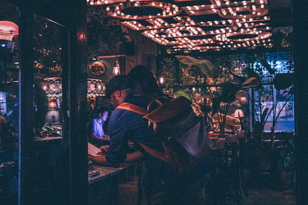 man leaning on table inside building thumbnail