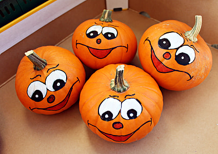 focus photography of four pumpkins with faces thumbnail