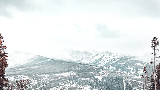 snow-covered mountains under white clouds during daytime thumbnail