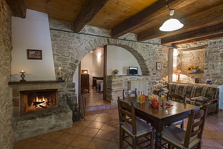 brown wooden dining table near chimney inside house thumbnail