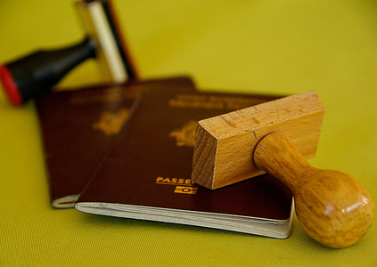 brown wooden stamper on passport book thumbnail