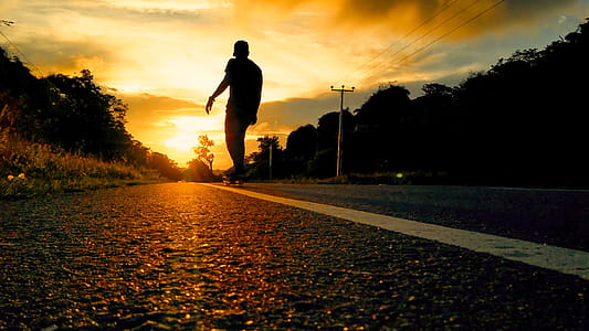 Silhouette Photo Of Man Riding Skateboard thumbnail