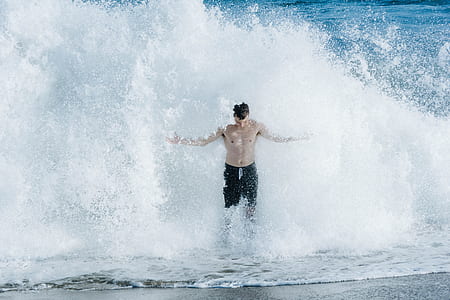 man standing near waves thumbnail