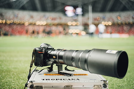 selective focus photography of black DSLR camera on train case thumbnail