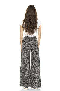 woman standing wearing black bottoms and white shirt thumbnail