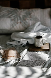 white ceramic mug on brown book thumbnail