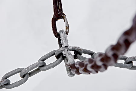 close-up photography of gray metal chain knotting each other thumbnail
