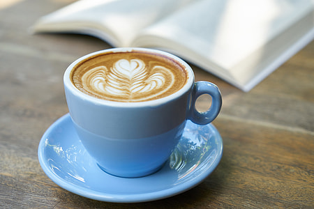 blue ceramic teacup with saucer on brown wooden surface thumbnail