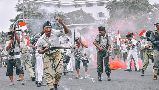group of men holding firearms on street thumbnail