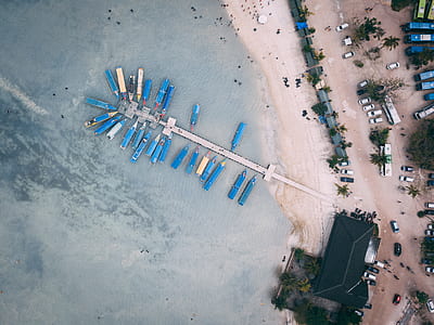 aerial photography of white sand beach with dock thumbnail
