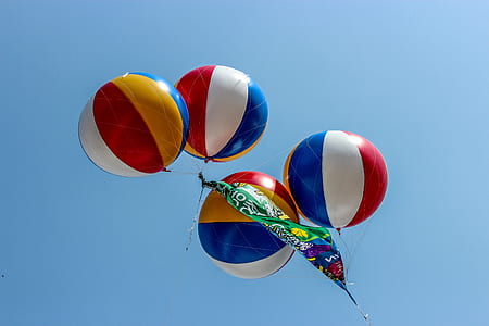 four assorted-color hot air balloons thumbnail