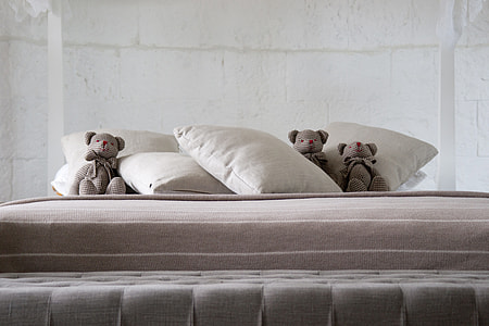 bear plush toy near pillow on bed thumbnail