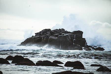 rock formation near ocean at daytime thumbnail