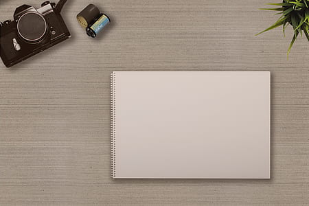 black DSLR camera near film and white paper thumbnail
