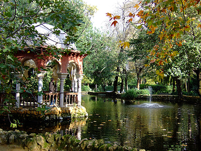 person in gazebo looking at trees near body of water thumbnail