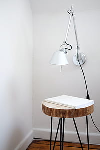 book on brown wooden table near wall thumbnail