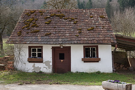 brown and white concrete house surrounded by green grass thumbnail