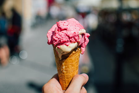 person holding melting ice cream cone thumbnail