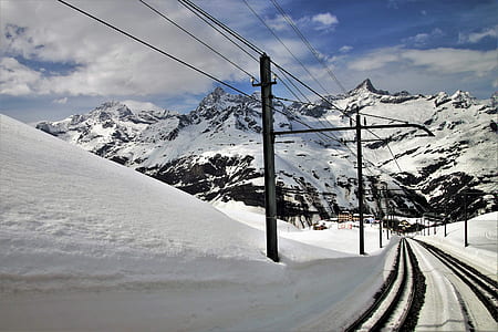 road covered with snow near alps mountain thumbnail