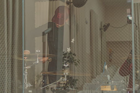 Man Standing Front of Drum in Room thumbnail