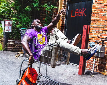 Man Sitting on Shopping Cart thumbnail