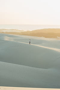 man standing on desert at daytime thumbnail