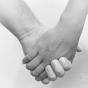 grayscale photography of person holding hands together thumbnail